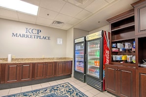 A KCP Marketplace with a counter, two beverage refrigerators, and a display cabinet.