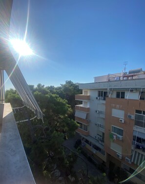 A multi-story building with balconies, air conditioning units, and a clear sky. - 2-bedroom apartment in lovely Golem with AC and comfort (Golem)