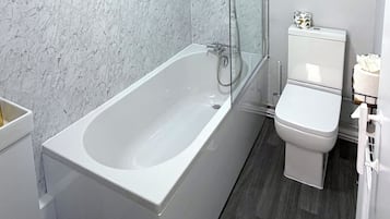 Combined shower/bathtub, deep-soaking bathtub, towels