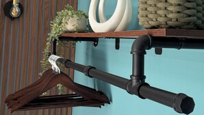 A wooden hanger with a white cloth, a black pipe, and a light bulb on a wall. - Central Hull, 3Br Contractors & Street Parking (Hull)