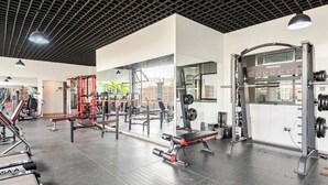 A gym with various exercise equipment, including weight machines and free weights. - Spacious Fully-stocked modern studio with a gym, cafe, & pitch in Kileleshwa (Nairobi)