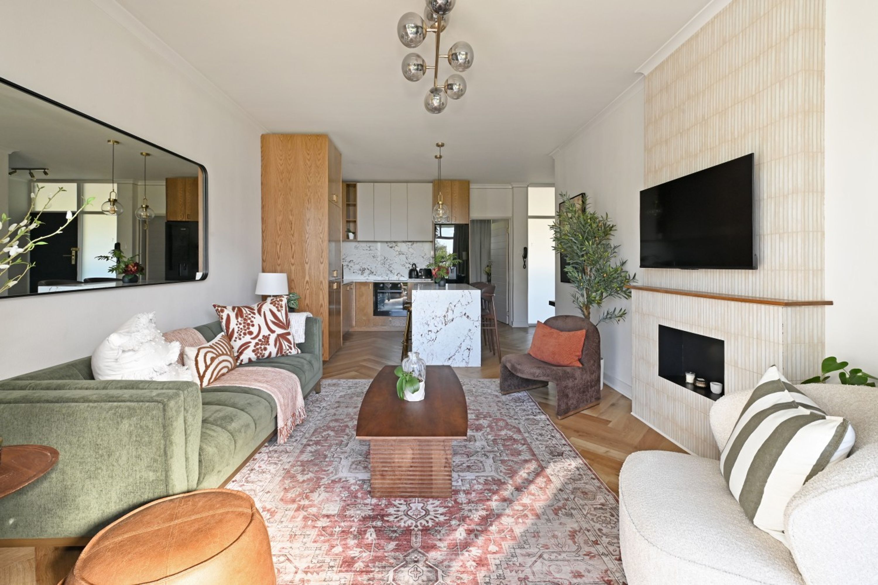A modern living room with a sofa, coffee table, and TV.