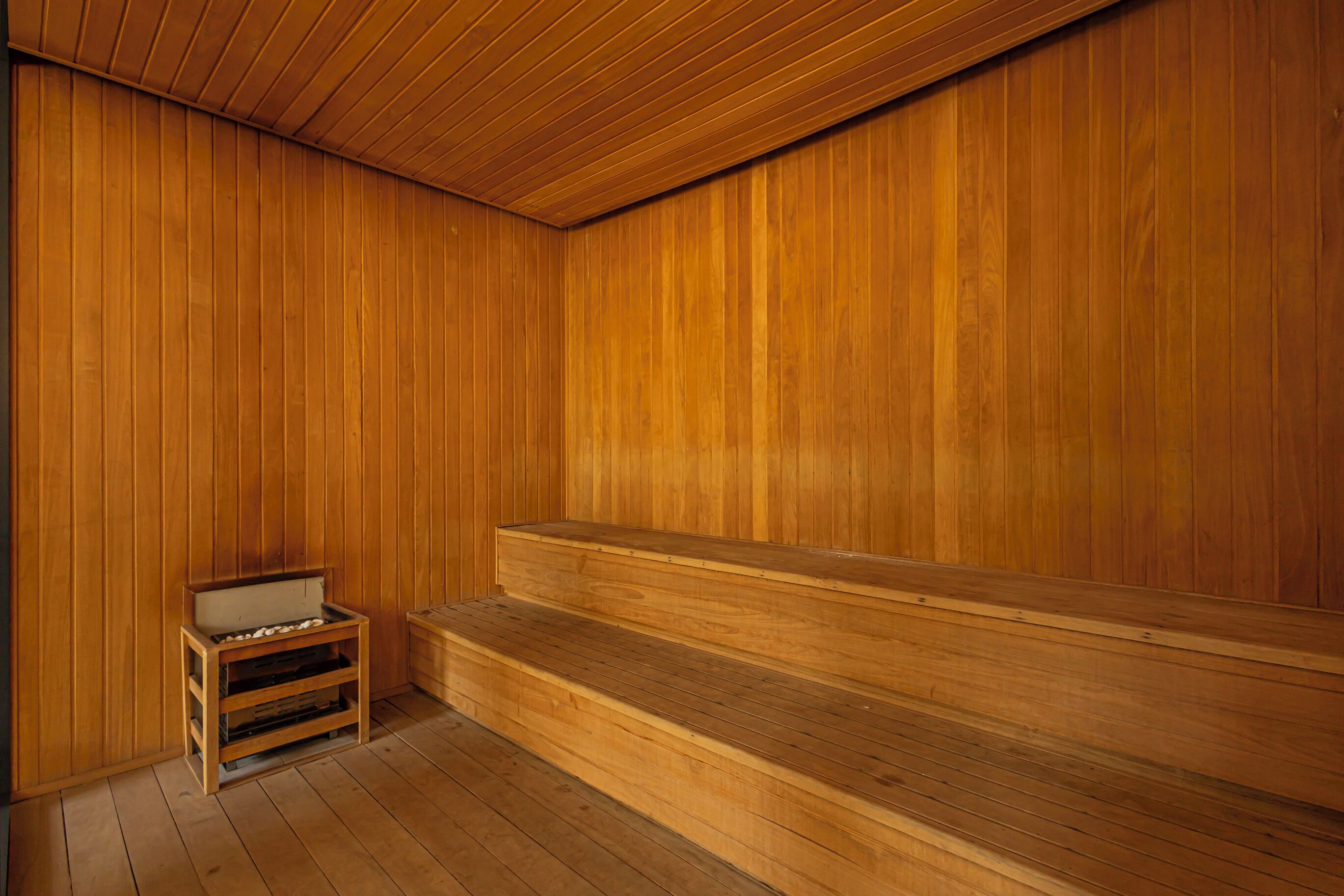 A sauna room with wooden walls and benches.