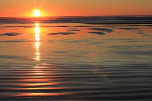 A beach with calm water reflecting the sunset. - Beachcomber's Retreat *Beach*Golf*Pets (Gearhart)