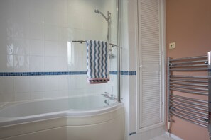 A bathroom with a bathtub, a shower, and a towel rack. - Wisteria Corner, Large Tranquil Family Home, Spacious, Edge of the Peak District (Chesterfield)