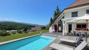 A swimming pool with a wooden deck, outdoor seating, and a view of mountains. -
Luxurious Villa Ella Talloires (Talloires-Montmin)