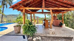 A wooden gazebo with a tiled floor, surrounded by potted plants and a pool. - Villa Bonita – Luxury Secluded Mountain Retreat in Costa Rica (Provincia de Guanacaste)