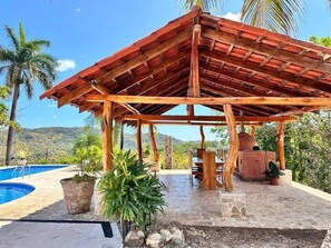A wooden gazebo with a tiled floor, surrounded by potted plants and a pool. - Villa Bonita – Luxury Secluded Mountain Retreat in Costa Rica (Provincia de Guanacaste)