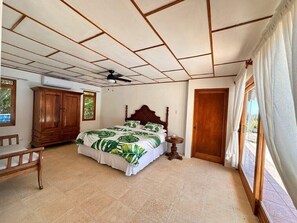 A bedroom with a bed, wooden wardrobe, and a window with curtains. - Villa Bonita – Luxury Secluded Mountain Retreat in Costa Rica (Provincia de Guanacaste)