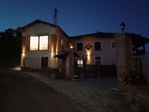 A two-story house with a visible garage, a gated entrance, and a street lamp. - Private Relax Apartment: Sauna and Mini Pool (Piemonte)