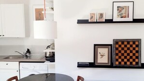 A modern kitchen with a round table, chairs, a dishwasher, and a radiator. - Stylish 2BR · Free Parking · Heart of Edinburgh (Edinburgh)