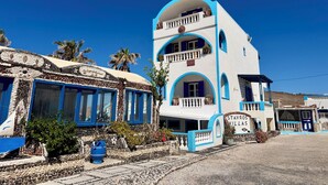 Um edifício de dois andares com uma placa que diz 'Stavros Villas'.