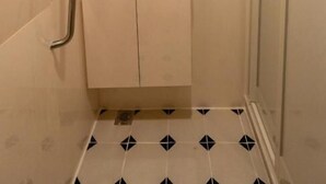 A small bathroom with a shower, a sink, and a mirror. - Train Pod at one-north (Singapore)
