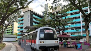 A train station platform with a train labeled 'Train Pod' and a covered waiting area with chairs. - Train Pod at one-north (Singapore)