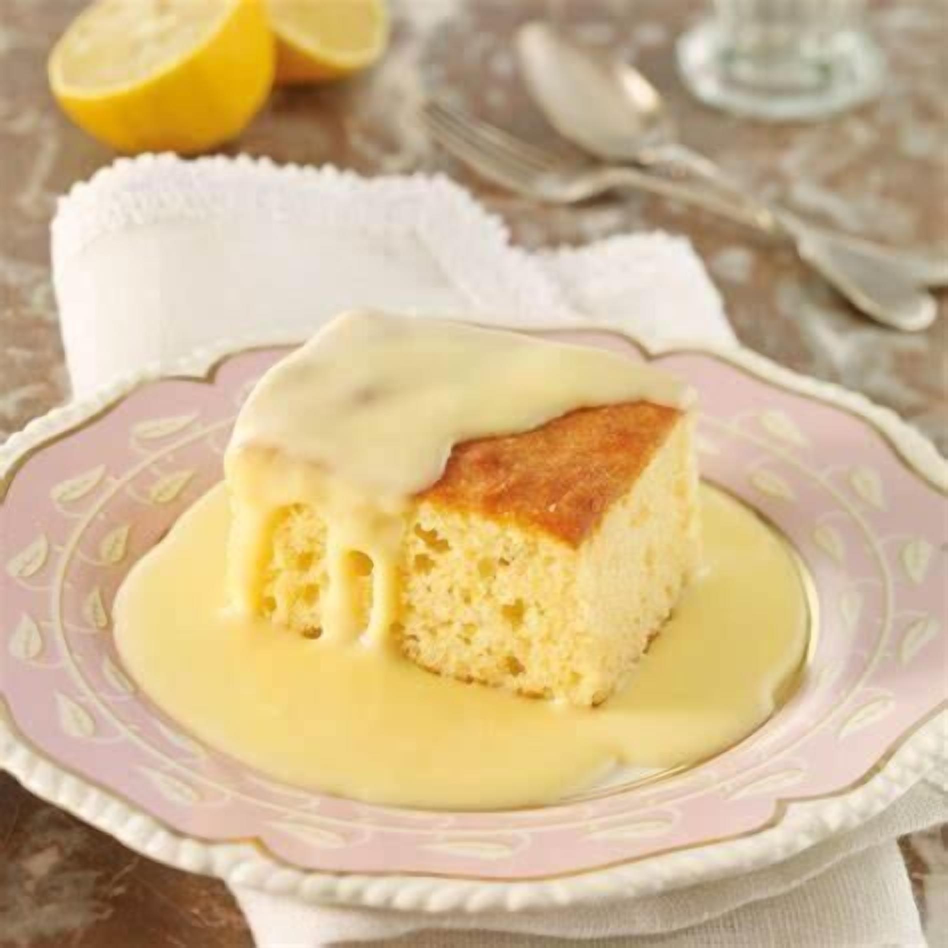 A piece of cake with a creamy topping on a decorative plate.