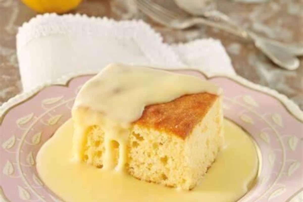 A piece of cake with a creamy topping on a decorative plate.