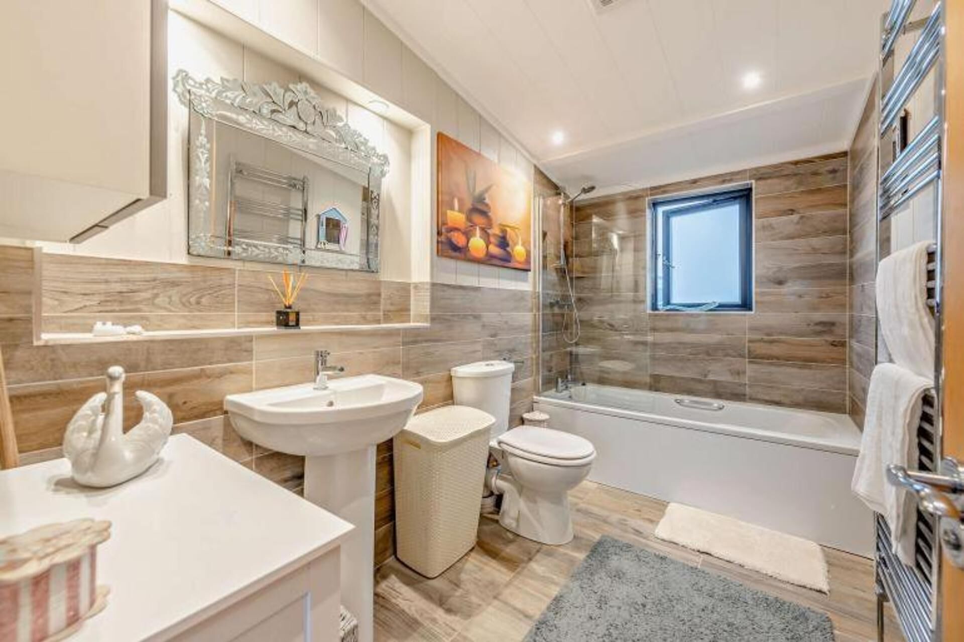 A modern bathroom with a sink, toilet, and shower.