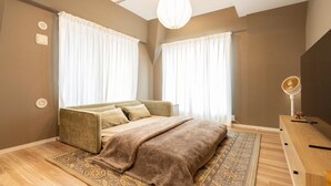 A bedroom with a bed, curtains, a bedside table, and a lamp. - Now Available - Spacious House in Yokohama/Chinatown, Grand Yokohama Stay (Yokohamashi Nakaku Yamashitacho)