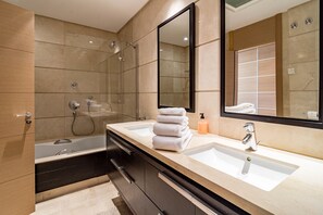 A modern bathroom with a double sink, a large mirror, a glass shower enclosure, and a dark-colored vanity. - BVQ - Stunning Sea & Golf View Terrace (Benahavis)