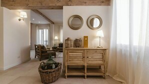A room with a wooden cabinet, two wall mirrors, a wicker basket, and a lamp. - Historic villa with private pool near Florence (Vinci)