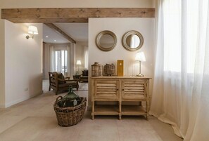 A room with a wooden cabinet, two wall mirrors, a wicker basket, and a lamp. - Historic villa with private pool near Florence (Vinci)