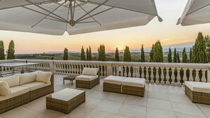 A terrace with outdoor furniture, a table, and a view of the landscape. - Historic villa with private pool near Florence (Vinci)