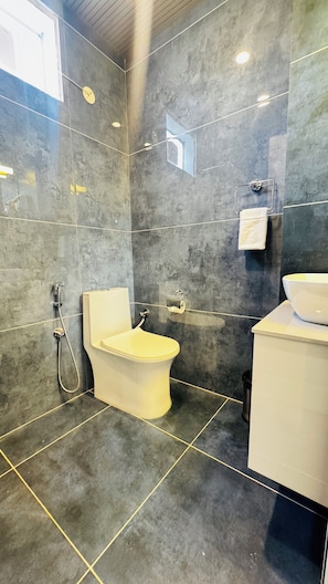 A modern bathroom with a toilet, bidet, and sink. - Arista Haven Hotel (Narendranagar)