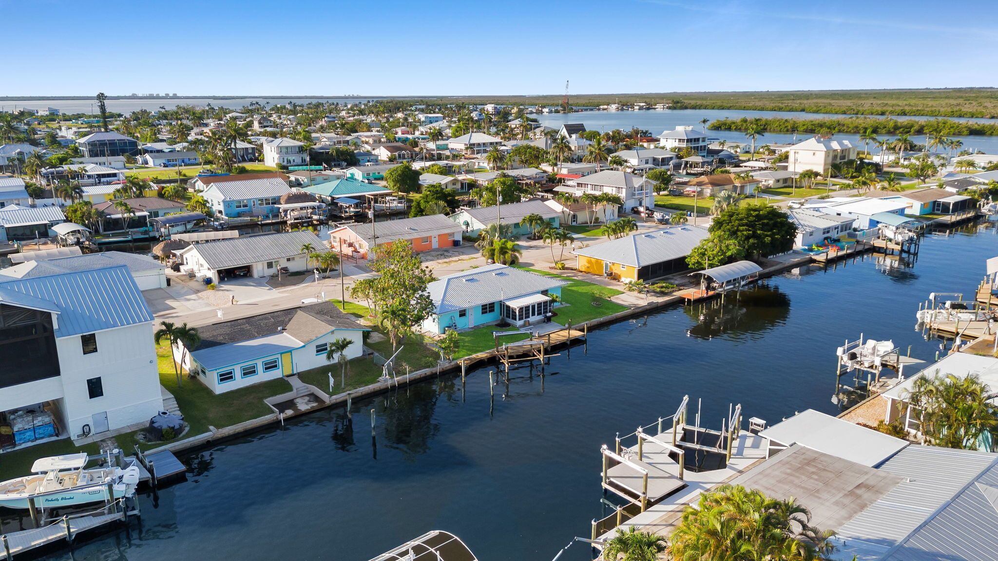 A residential area with houses, docks, and a marina.