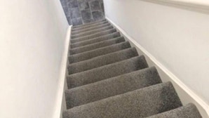 A carpeted staircase with a white handrail and a stone wall at the top. - Double Rooms End Terrace Close to Kettering Town (Corby)