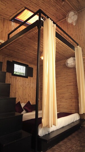 A room with a bed, a TV, a fan, and a staircase. - Bhimtal Hotel nr. Bhowali Range Arahnyam (Bhimtal)