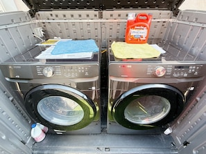 Two front-loading washing machines in a vehicle's cargo area. - Cozy 2-bedroom house No Living room (San Gabriel)