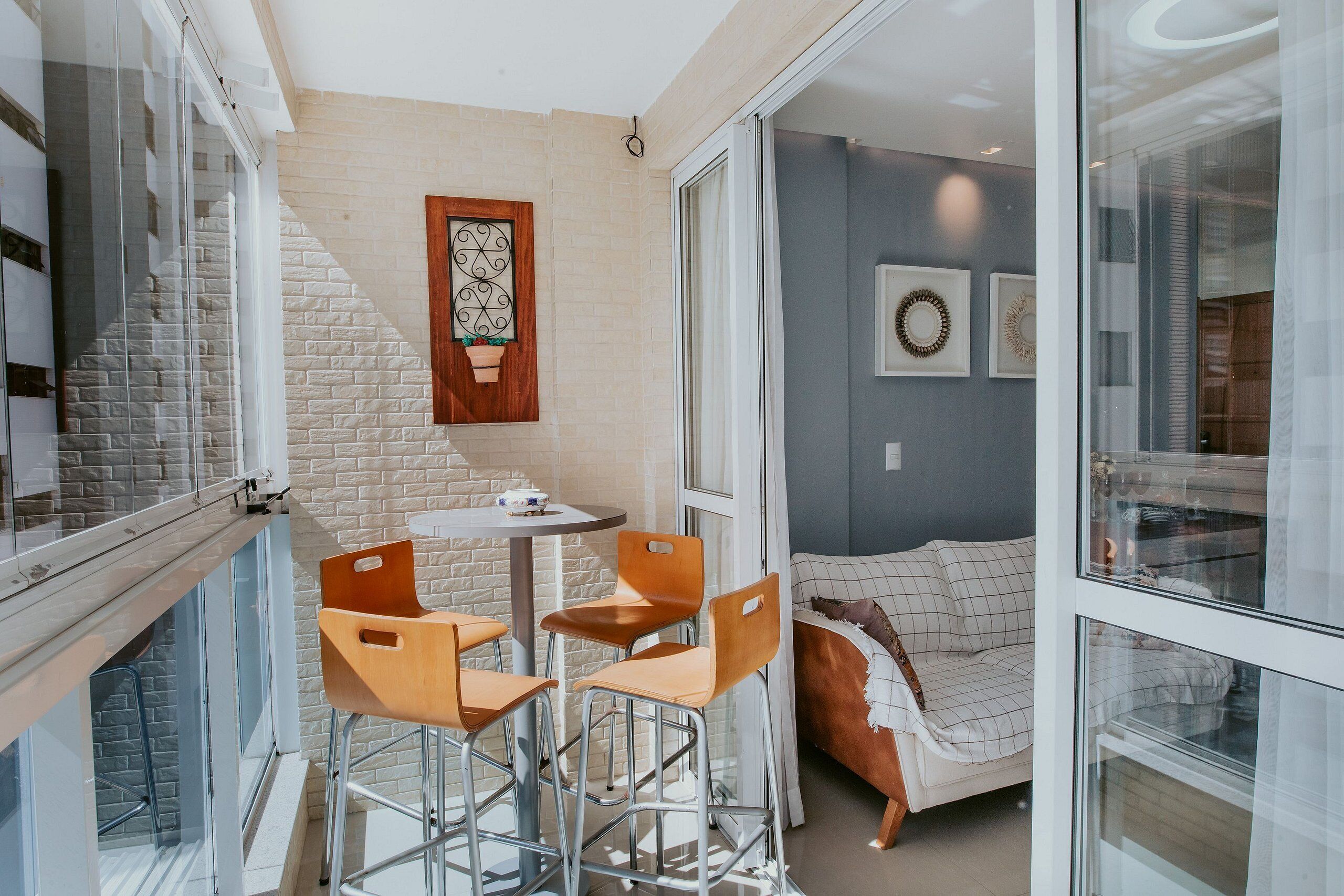 A modern interior with a dining area, a sofa, and a staircase.