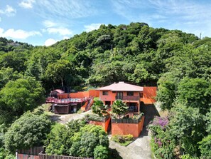 A hillside property with a two-story building, a pool, and lush greenery. - Careffe Escape (Gros Islet)