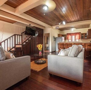 A spacious living area with a wooden ceiling, a sofa set, a dining area, and a staircase. - Careffe Escape (Gros Islet)