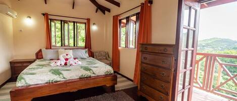 Un dormitorio con cama, cómoda y balcón con vistas.