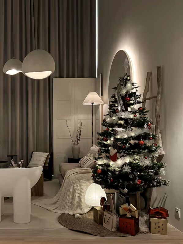 A modern living room with a Christmas tree, a sofa, a coffee table, and a lamp. - Comfy Loft in EkoCheras, Link to MRT | 1-6 pax (Kuala Lumpur)
