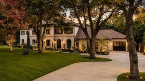 A two-story house with a driveway leading to a garage. - Grand Luxury 11,000 sq ft Estate — 6BR, 8BA, Pool & Premium Finishes (Dallas)