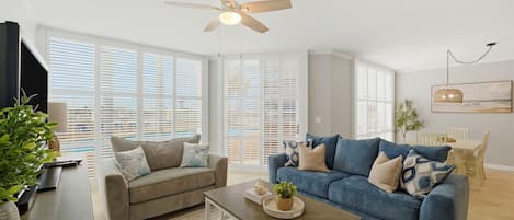 A living room with two sofas, a coffee table, and a ceiling fan.