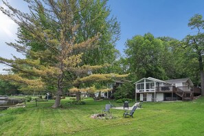 A house with a large deck, a fire pit, and outdoor seating. - Lakefront 2 bedroom house in Zimmerman on Elk Lake (Zimmerman)