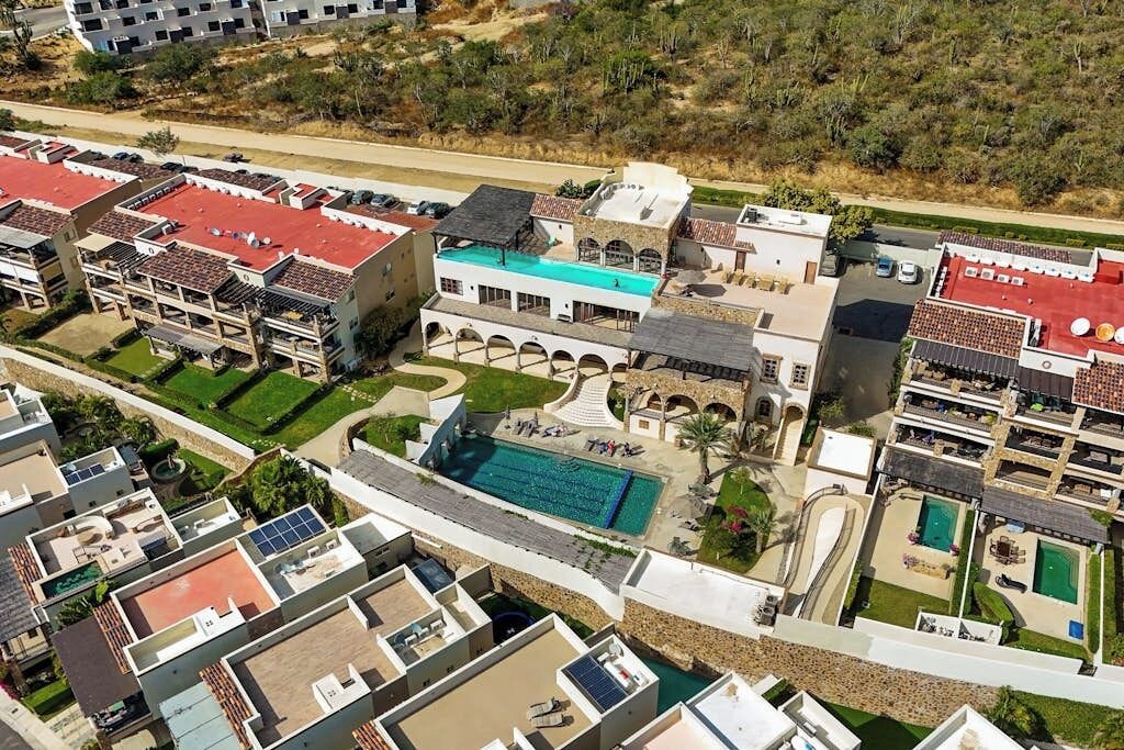 A residential complex with multiple buildings, a central courtyard, and a swimming pool.