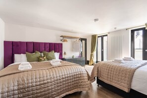 Two beds with headboards, a bedside table, a mirror, and a window with curtains. - Fun Kemptown Stay w/ Games Close to the Seafront (Brighton and Hove)