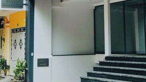 A modern building with a sign reading 'Clever Space' and a staircase leading to the entrance. - Studio Suite Deluxe 35m2 with Balcony (Hà Nội)