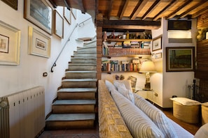 A staircase leading to a loft area with a bookshelf and a cozy seating area. - La Corte Dei Limoni - Countryside Retreat with Mountain View, Wi-Fi & Air Conditioning (Nocchi)