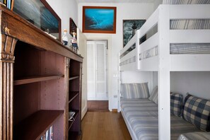 A room with a bunk bed, wooden shelves, and a door leading to another room. - La Corte Dei Limoni - Countryside Retreat with Mountain View, Wi-Fi & Air Conditioning (Nocchi)