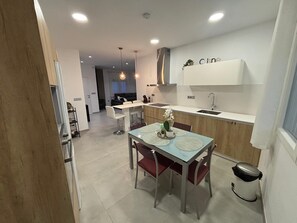 A modern kitchen with a dining area, a built-in oven, and a sink. - La Pinada del Acueducto, ideal house to relax and rest. (Fortuna)