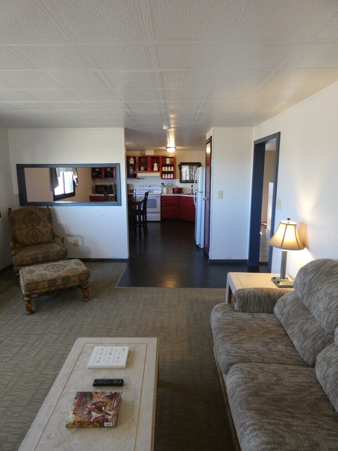 A compact living space with a kitchenette, a dining area, and a sofa.