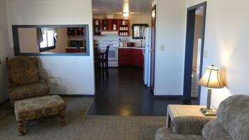 A compact living space with a kitchenette, a dining area, and a sofa.
