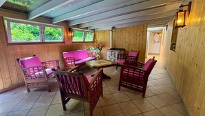 A wooden interior with a sofa, chairs, a table, and a map on the wall. - Large house with garden and terrace in Lapoutroie (Lapoutroie)