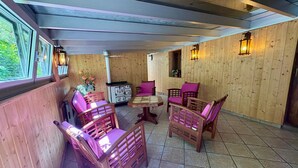 A wooden-paneled room with a dining table, chairs, and a cabinet. - Large house with garden and terrace in Lapoutroie (Lapoutroie)