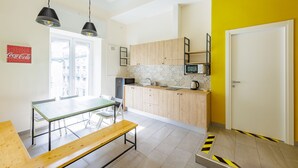 A modern kitchen with a dining area, a microwave, and a sink. - Central Station Housing Apartment1 (Naples)